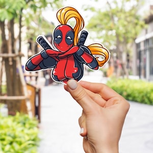Puede incluir: Un personaje de dibujos animados rojo y negro con una máscara roja y cabello amarillo. El personaje sostiene un par de espadas y tiene una expresión juguetona.