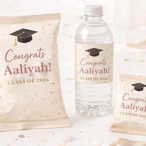 May include: Graduation-themed party favors, including a water bottle and two snack bags. Each item features a graduation cap graphic and the text "Congrats Aaliyah! Class of 2026" in a stylish font, with a beige and gold confetti design.