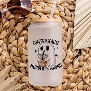 May include: A white ceramic mug with a black handle and the text "But First, Coffee" in a black, bold font. The mug is on a white surface. The mug is approximately 10 cm tall.