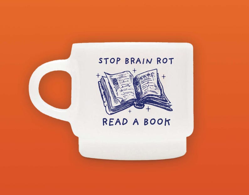 May include: White ceramic mug with a blue illustration of an open book and the text "STOP BRAIN ROT READ A BOOK".
