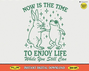 May include: Green line art illustration of a rabbit and a frog dancing with stars around them. The text "NOW IS THE TIME TO ENJOY LIFE While You Still Can" is below the image.