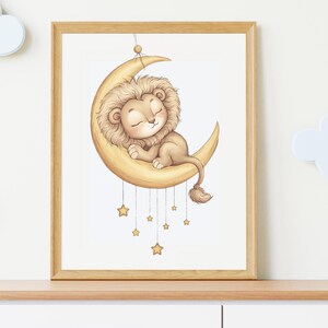 May include: A framed illustration of a sleeping lion cub on a crescent moon. The lion has a tan mane and is resting on a yellow moon. Several gold stars hang below the moon. The artwork is in a wooden frame.