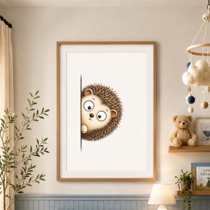 May include: A framed wall art print featuring a cartoon illustration of a brown hedgehog peeking out from behind a vertical black line. The hedgehog has large white eyes, a small black nose, and textured quills, set against a plain white background.