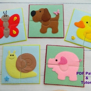 May include: Five felt animal puzzles: a red butterfly, a brown dog, a yellow duck, a yellow snail, and a pink pig. Each puzzle is made of two pieces and set on a square background.