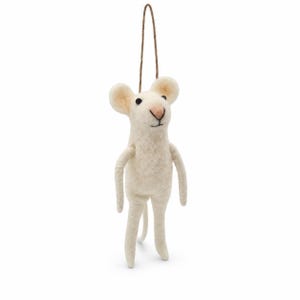May include: A cream-colored felted wool mouse ornament featuring a soft, rounded body, two large ears, a small pink nose, and black bead eyes. The mouse has thin arms and legs, a long tail, and a brown string loop attached to the top for hanging.