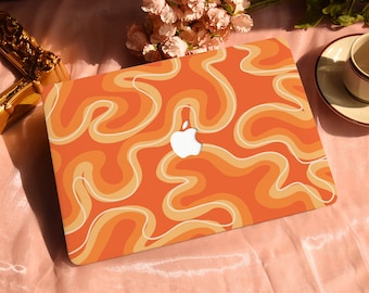 May include: Orange and white laptop skin with a swirling abstract pattern. The skin has a white Apple logo in the centre.