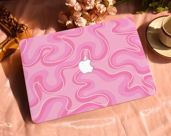 May include: Pink laptop skin with a white swirl pattern. The skin has the Apple logo in the centre.