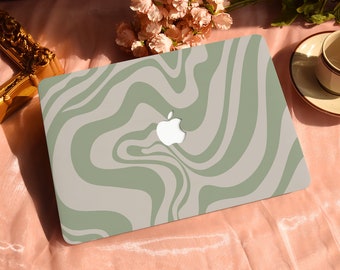 May include: A laptop computer with a green and white swirl pattern on the lid. The Apple logo is visible on the lid.