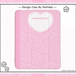 May include: Pink phone case with a white heart design that says "COMPOSITION" on it. The case has a pink and white speckled pattern.