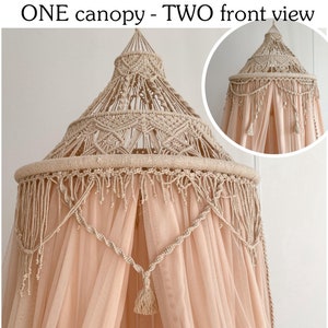 May include: A beige macrame canopy with a peach-colored sheer fabric draped over it. The canopy has a tassel hanging from the center.
