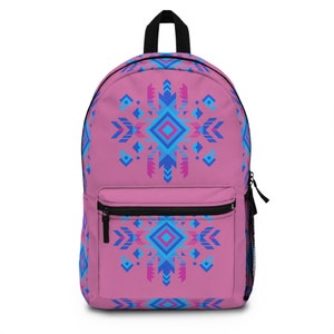 May include: Pink backpack with a geometric pattern in shades of blue and pink. The pattern features a central diamond shape with arrows and other geometric shapes.