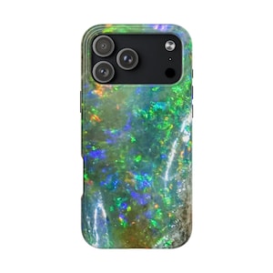 May include: A smartphone case with a colorful, iridescent design. The case features a black camera module with three lenses. The case's surface has a mix of green, blue, and orange hues, creating a shimmering effect.