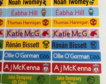May include: A collection of colorful name labels with various names and graphics. The labels feature names like "David Blake", "Sophie McClure", and "Noah Twomey". Each label has a different color background and a small graphic.