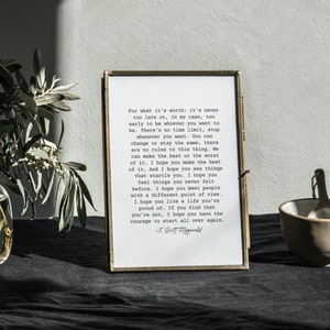 Könnte beinhalten: Ein gerahmter Druck mit einem Zitat von F. Scott Fitzgerald in Schwarzweiß-Schreibmaschinenschrift. Das Zitat lautet: "Für das, was es wert ist: Es ist nie zu spät oder, in meinem Fall, zu früh, um zu sein, wer du sein willst. Es gibt keine Zeitbegrenzung, höre auf, wann immer du willst. Du kannst dich ändern oder gleich bleiben, es gibt keine Regeln für dieses Ding. Wir können das Beste oder das Schlimmste daraus machen. Ich hoffe, du machst das Beste daraus. Und ich hoffe, du siehst Dinge, die dich überraschen. Ich hoffe, du fühlst Dinge, die du noch nie zuvor gefühlt hast. Ich hoffe, du triffst Menschen mit einer anderen Sichtweise. Ich hoffe, du lebst ein Leben, auf das du stolz bist. Wenn du feststellst, dass du es nicht bist, hoffe ich, dass du den Mut hast, ganz von vorne anzufangen. - F. Scott Fitzgerald"