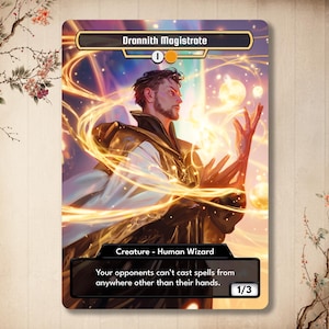 May include: A fantasy card featuring "Drannith Magistrate," a Human Wizard. The card has a gold and black border with the text "1/3" at the bottom. The artwork depicts a man with a beard, surrounded by golden energy, with the text "Your opponents can't cast spells from anywhere other than their hands."