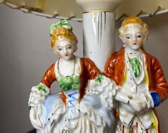 Vintage table lamp featuring ''A lady and a gentleman'' with great attention to detail, colours and gold accents, Germany.