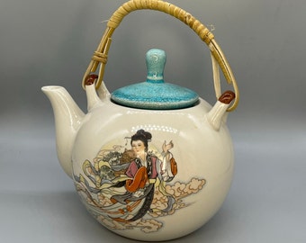 Vintage Feng Cheng teapot with a bamboo handle and hand-painted Geisha motifs, China, the 1980s.