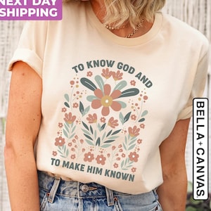 May include: A beige t-shirt with a floral design and the text "To know God and to make Him known".