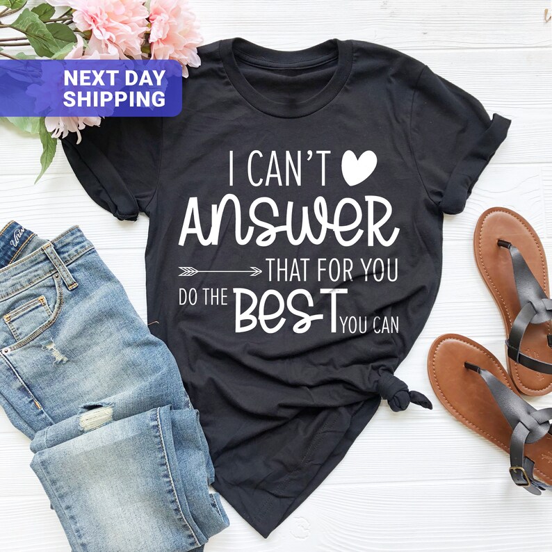 May include: Black t-shirt with white text that reads "I can't answer that for you, do the best you can". A white heart is next to the word "can't".