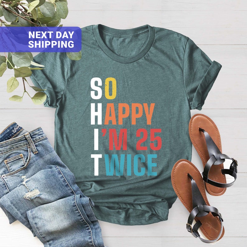 May include: Teal blue t-shirt with the text "SO HAPPY I'M 25 TWICE" in colorful retro-style lettering.