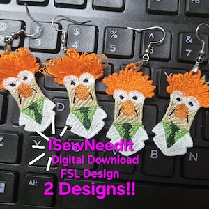 May include: Embroidered earrings featuring a cartoon character with orange hair, a beige face, and a green tie. The earrings are on a keyboard with the text "I SewNeedIt Digital Download FSL Design 2 Designs!!".