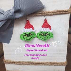 Puede incluir: Un par de pendientes de Grinch de color verde y rojo con ribete blanco. Los pendientes son de encaje independiente y son una descarga digital. El texto "ISewNeedIt" está en el cartel debajo de los pendientes.