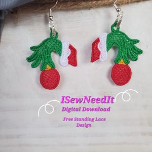 May include: A pair of green and red Christmas tree-shaped earrings with a white Santa hat on top. The earrings are made of free-standing lace and are available as a digital download. The text "ISewNeedIt Digital Download Free Standing Lace Design" is visible below the earrings.