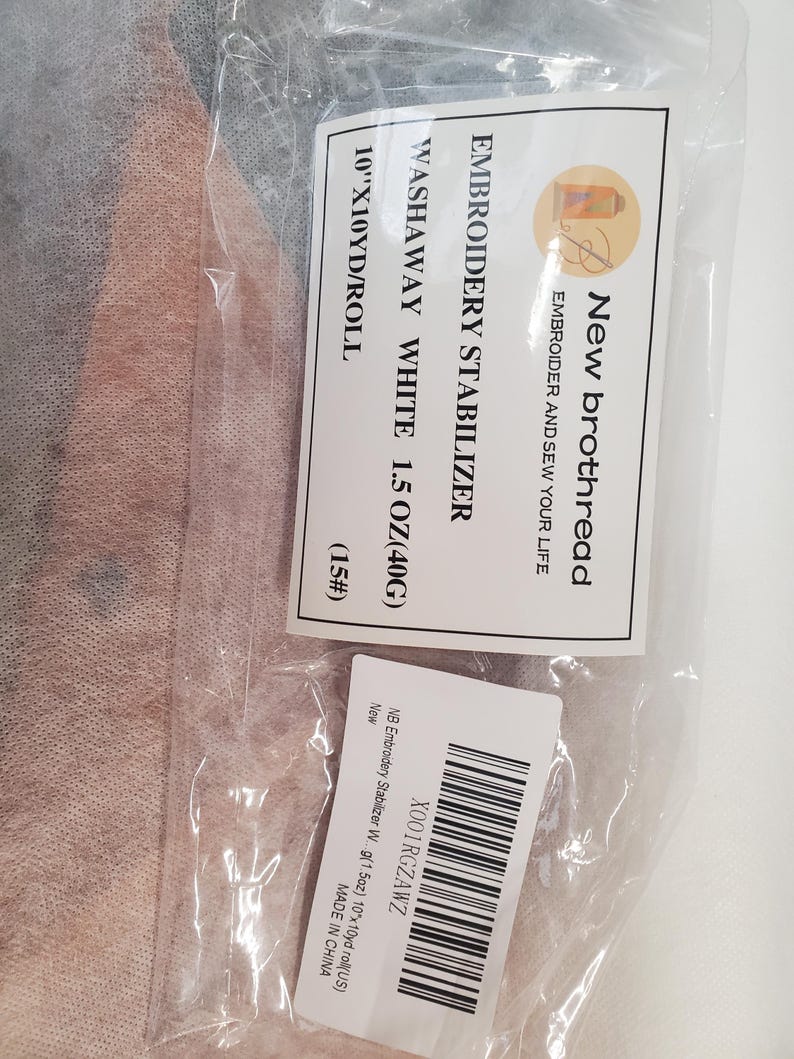 May include: A package containing white washaway embroidery stabilizer. The label reads "New brothread EMBROIDERY STABILIZER WASHAWAY WHITE 1.5 OZ (40G) 25.4cm x 9.14m/ROLL". The package also includes a barcode and the text "MADE IN CHINA".