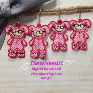 May include: Three pink bunny-shaped earrings with black glasses and pink accents. The earrings are free-standing lace designs and are available for digital download. The text "iSewNeedIt" is also visible in the image.