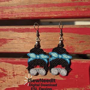 May include: Embroidered dangle earrings depicting a woman's face with a messy bun, sunglasses, and a blue bow. The earrings have silver-coloured hooks. The image includes the text "iSewNeedIt / Digital Download FSL Design."