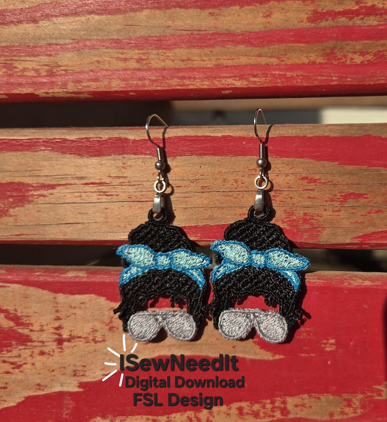 May include: Embroidered dangle earrings depicting a woman's face with a messy bun, sunglasses, and a blue bow. The earrings have silver-coloured hooks. The image includes the text "iSewNeedIt / Digital Download FSL Design."