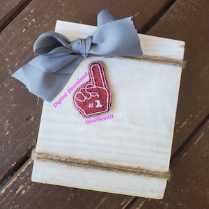 May include: A white wooden sign with a red glitter foam finger with the number "#2" on it. The sign is decorated with a gray bow and twine. The text "Digital Download" and "iSewNeedIt" are written on the sign.