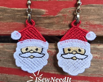 May include: A pair of Santa Claus-themed earrings. Each earring features a red Santa hat with white trim and a white beard. The text "I Sew Need It" and "Digital Download FSL Design" is visible.