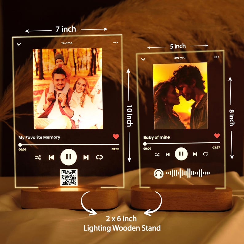May include: Two illuminated photo frames with a music player design. The frames are 7 inches by 10 inches and 5 inches by 8 inches. The frames are on a 2 by 6 inch wooden stand. The frames have a heart icon, a play button, a pause button, a next button, a previous button, and a QR code.