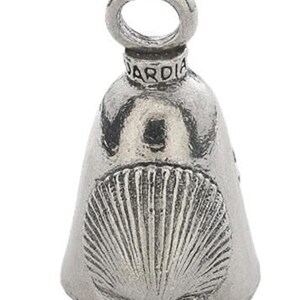 May include: A silver-colored bell-shaped charm with a loop at the top. The word "ARDIA" is engraved on the top. The bell features a detailed seashell design on the front.