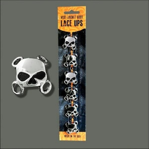 May include: A set of six silver skull-shaped zipper pulls, packaged on a card with the text "Vest Jacket Boot Lace Ups" and "Made in the USA".