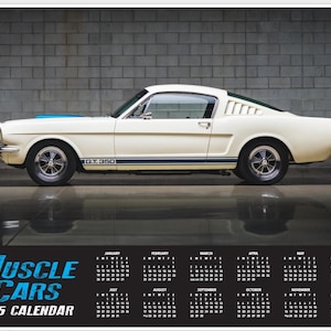 May include: A white 1965 Ford Mustang GT350 muscle car with a blue stripe on the hood. The car is parked in front of a brick wall. The image includes a 2025 calendar with the words "Muscle Cars" at the top.