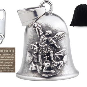 May include: Silver motorcycle bell with a detailed design of a winged angel riding a dragon. The bell is attached to a silver loop and has a black velvet pouch.