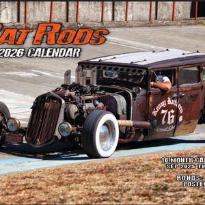 May include: A 2026 calendar featuring a rusty brown Rat Rod car with white-walled tires. The calendar has the text "Rat Rods" and "2026 Calendar" in orange. The car has the text "Krazy Autters 76" on the side. Includes a bonus poster.