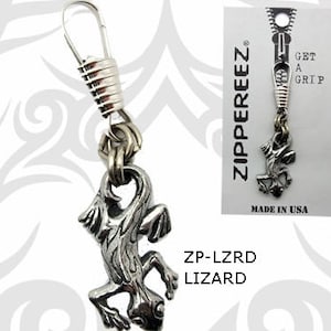 May include: Silver zipper pull charm featuring a lizard design. The charm is attached to a silver spring and a silver loop. The charm is labeled "ZP-LZRD LIZARD" and "GET A GRIP" and "MADE IN USA".