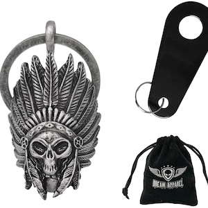 May include: A silver-colored keychain pendant featuring a Native American headdress design with a skull face. Includes a black key tag and a black drawstring bag with the text "DREAM APPAREL" and a skull logo.
