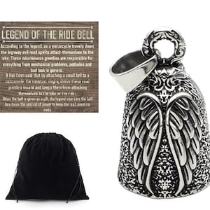 May include: A silver motorcycle handlebar bell with a detailed design of angel wings. The bell is attached to a black velvet pouch. The text on the wooden sign reads "Legend of the Ride Bell" and explains the legend of the bell and its purpose.