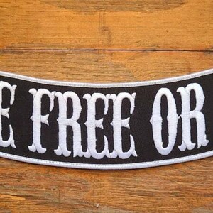 May include: Black and white embroidered patch with the text "LIVE FREE OR DIE" in a curved banner style.