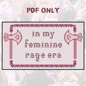 May include: Cross-stitch pattern with pink hearts and axes, featuring the text "in my feminine rage era".