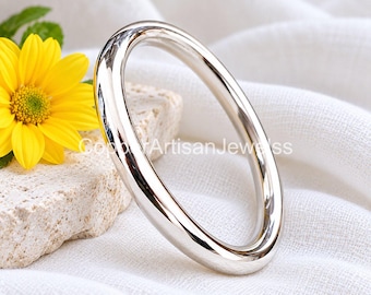 May include: A polished silver-tone bangle bracelet with a smooth, rounded surface. The metal band has a high-shine reflective finish. The text "CopperArtisanJewels" is visible across the center of the image, partially overlapping the silver bangle.