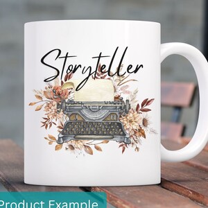 May include: White ceramic mug with a black and white illustration of a vintage typewriter with floral accents. The text "Storyteller" is written in black script above the typewriter.