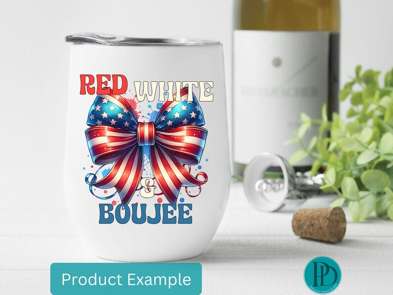 May include: A white stemless wine tumbler with a patriotic design. The tumbler features a red, white, and blue bow with the words "Red White & Boujee". A bottle of wine, a cork, and greenery are in the background.