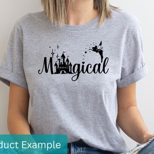 May include: A gray t-shirt with a black graphic of a castle, a fairy, and the word "Magical".