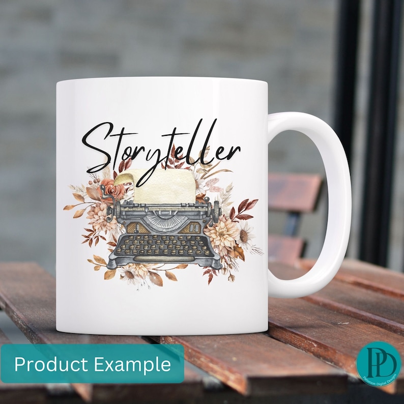 May include: White ceramic mug with a black and white illustration of a vintage typewriter with floral accents. The text "Storyteller" is written in black script above the typewriter.