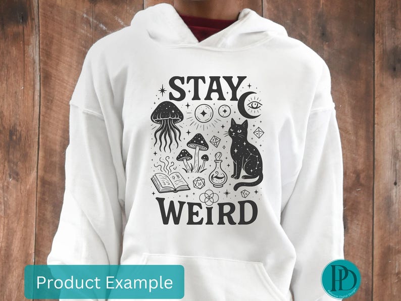 May include: White hoodie with a black graphic design featuring a cat, mushrooms, and the words "STAY WEIRD". The design includes a jellyfish, an open book, and other mystical elements. The hoodie has a front pocket and a drawstring hood.